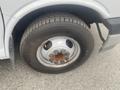 A close-up of a tire on a 2017 Chevrolet Express showing the wheel rim and lug nuts