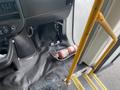 Interior view of a 2017 Chevrolet Express showing a fire extinguisher positioned on the floor near the door and a mounted pole next to it