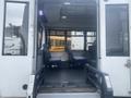 Interior of a 2017 Chevrolet Express showcasing two blue seats and a wheelchair ramp leading into the vehicle