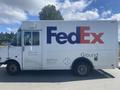 A white 1999 Ford Econoline delivery truck with the FedEx logo on its side