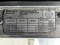 A metal identification plate from a 2014 Kenworth T370 displaying details such as manufacturer information and specifications