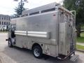A silver 2007 Morgan Olson Workhorse W42 delivery truck with a streamlined design and multiple side compartments for storage