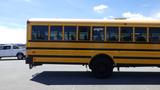 A yellow 2014 International 3000 school bus with multiple windows along the side