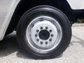 Close-up of a black tire mounted on a silver wheel with eight black lug nuts and a central hubcap on a Morgan Olson Workhorse W42 vehicle