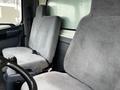 Interior of a 2006 Hino 268 featuring two gray upholstered seats with seatbelts and a view of the dashboard area
