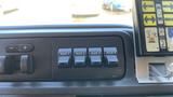 Dashboard control panel of a 2013 Ford Econoline featuring four auxiliary switches labeled AUX 1 AUX 2 AUX 3 AUX 4