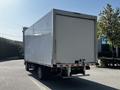 A white 2020 Hino 195 truck with a closed cargo box is parked in a lot facing away from the camera
