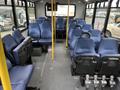 Interior seating layout of a 2017 Chevrolet Express with multiple blue seats arranged in rows and a clear aisle down the middle