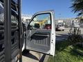 A 2016 Ford F-350 SD with an open driver's door showing the interior details and a view of the side mirror