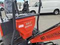 A red AGT Mini Excavator with industrial branding featuring a seat and control levers visible in the foreground