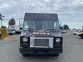 A black 2011 Ford Utilimaster Food Truck with a distinct graphic design on the front and large windshield