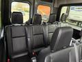 Interior view of a 2019 Mercedes-Benz Sprinter showing black leather seats arranged in a row with seatbelts