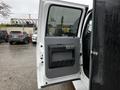 A 2014 Ford F-550 door is opened showing the interior handle and storage compartment