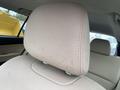 A front seat headrest of a 2019 Subaru Outback with visible stains on the beige upholstery