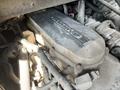 A close-up view of a dirty engine cover with visible wiring and components from a 2010 Freightliner MT45 Garbage Truck