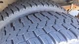 A close-up view of a tire from a 2006 Ford Econoline showing deep tread patterns and textured rubber surface