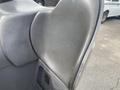 A close-up view of the gray seat of a 2004 Crown RR5210-35 with a curved backrest design