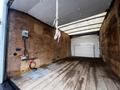 A 2017 Ford Econoline cargo van interior with wooden paneling and a wooden floor featuring electrical outlets and a rope hanging from the ceiling