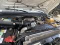 A 2010 Ford F-550 engine with a turbo diesel system visible featuring various components including a large air intake and battery
