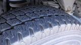 A close-up view of a tire from a 2006 Ford Econoline showcasing its tread pattern and surface details