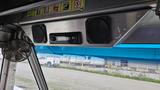 Interior view of a 2006 Ford Econoline with speakers and a radio mounted above the dashboard