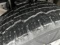 Close-up of a thick treaded tire from a 2011 Ford F-250 SD showing wear and texture details