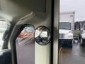 A 2012 Chevrolet Express interior view featuring a round side mirror reflecting the cabin and outside vehicles