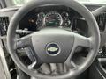 Steering wheel of a 2016 Chevrolet Express with a central Chevy logo and dashboard gauges visible in the background