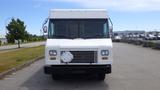 A white 2011 Ford Econoline van with a flat front and large windshield parked in a lot