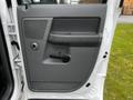 A 2008 Dodge Ram 5500 door panel featuring a speaker grille door handle and control buttons in a gray finish