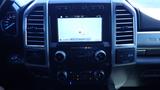 Interior dashboard of a 2017 Ford F-350 SD featuring a central touchscreen display with navigation controls and knobs for climate control