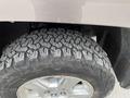 Tire of a 2013 Chevrolet Silverado Hybrid showing deep treads for off-road capability