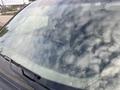 A 2010 Dodge Ram with a reflection of clouds on the windshield