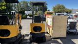 A 2021 Cael-1T Mini excavator in yellow with a compact design and tracks is positioned next to a wooden crate and other machinery