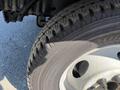 Close-up of a 2011 Ford Econoline tire showcasing the tread pattern and wheel rim details