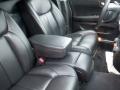 Interior view of a 2008 Cadillac Limousine showcasing black leather seats with a center console and armrests