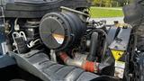 Close-up of the engine compartment of a 2009 International 4300 featuring a large black air filter and various hoses and pipes connected to the engine components