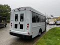 A 2015 Chevrolet Express van with a white exterior featuring large rear windows and dual back doors