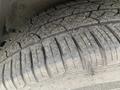 Close-up of a tire from a 2021 Lexus NX 300 showing detailed tread patterns and some dirt on the surface