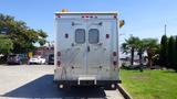 A silver 2005 Morgan Olson Workhorse delivery truck with double rear doors and metal grilles