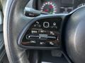 Steering wheel controls of a 2022 Mercedes-Benz Sprinter including buttons for cruise control and various settings