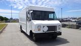 A white 2011 Ford Econoline delivery van with a large front grille and a flat nose parked on a paved area