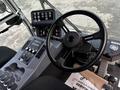 Control panel and steering wheel of a 2007 Tennant Sentinel featuring various buttons levers and gauges