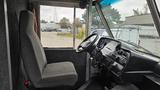 Interior of a 2006 Ford Econoline showing the driver's seat and dashboard with steering wheel and controls