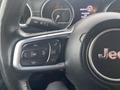 Close-up of the steering wheel of a 2020 Jeep Wrangler showing buttons for making calls and controlling settings