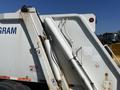 2010 Freightliner MT45 garbage truck with hydraulic lift system and safety warning labels