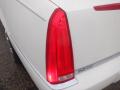 Close-up view of the rear light of a 2008 Cadillac Limousine with a sleek design showcasing a red lens and chrome detailing