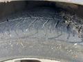 Close-up of a worn tire from a 2012 Kia Sportage showing visible tread patterns and dirt accumulation on the surface