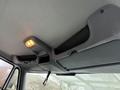 Interior view of a 2007 International 4200 featuring a ceiling light and storage compartment with a mesh netting