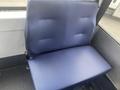 A blue upholstery seat from a 2017 Chevrolet Express with a simple, flat design and no visible seatbelt